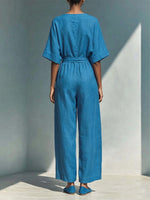 Wrap-style Deep V-neck Short-sleeve Cotton-linen Wide-leg Jumpsuit Featuring A Matching Self-tie Belt And Side Wooden Button Detail.