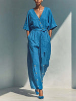 Wrap-style Deep V-neck Short-sleeve Cotton-linen Wide-leg Jumpsuit Featuring A Matching Self-tie Belt And Side Wooden Button Detail.